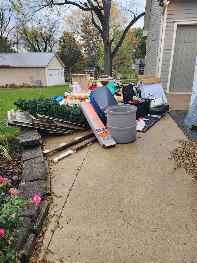 Dumpster being loaded with debris for 12 Yard Dumpster Rental in Luray